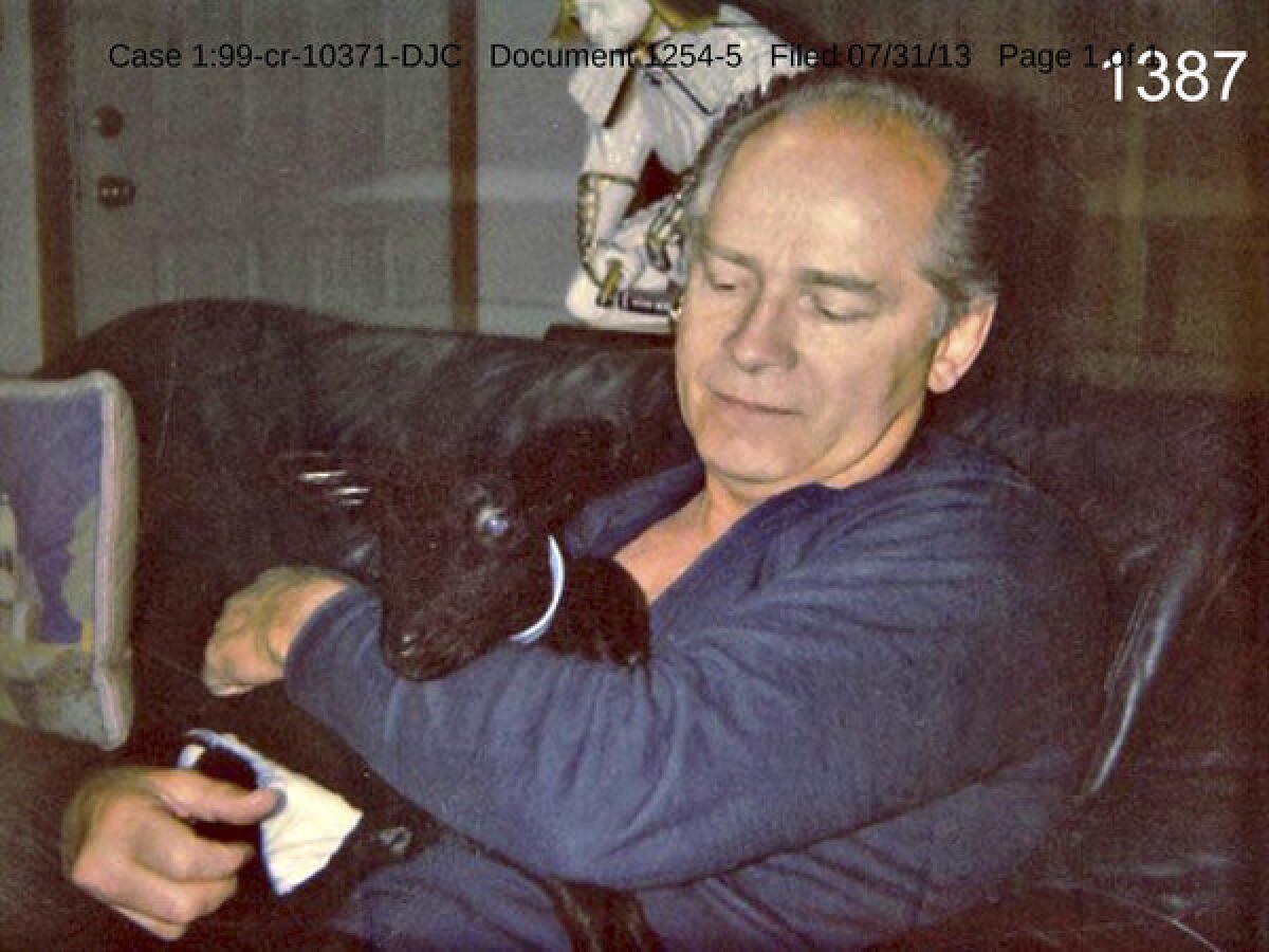 This undated photo filed in federal court in Boston by defense attorneys for James "Whitey" Bulger on Wednesday shows Bulger holding a goat at an unknown location. The photo was among several that showed a softer side of Bulger, which prosecutors complained were an attempt to salvage his reputation.