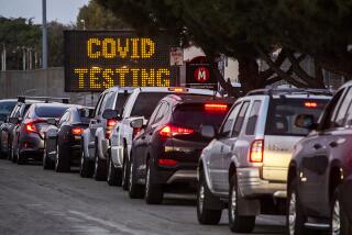 Motorists line up to take COVID-19 tests at at Long Beach City College-Veterans Memorial Stadium.
