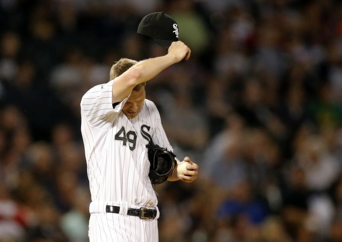 White Sox starter Chris Sale wipes the sweat from his face as he prepares to pitch in the fourth inning against the Angels on Monday night in Chicago.