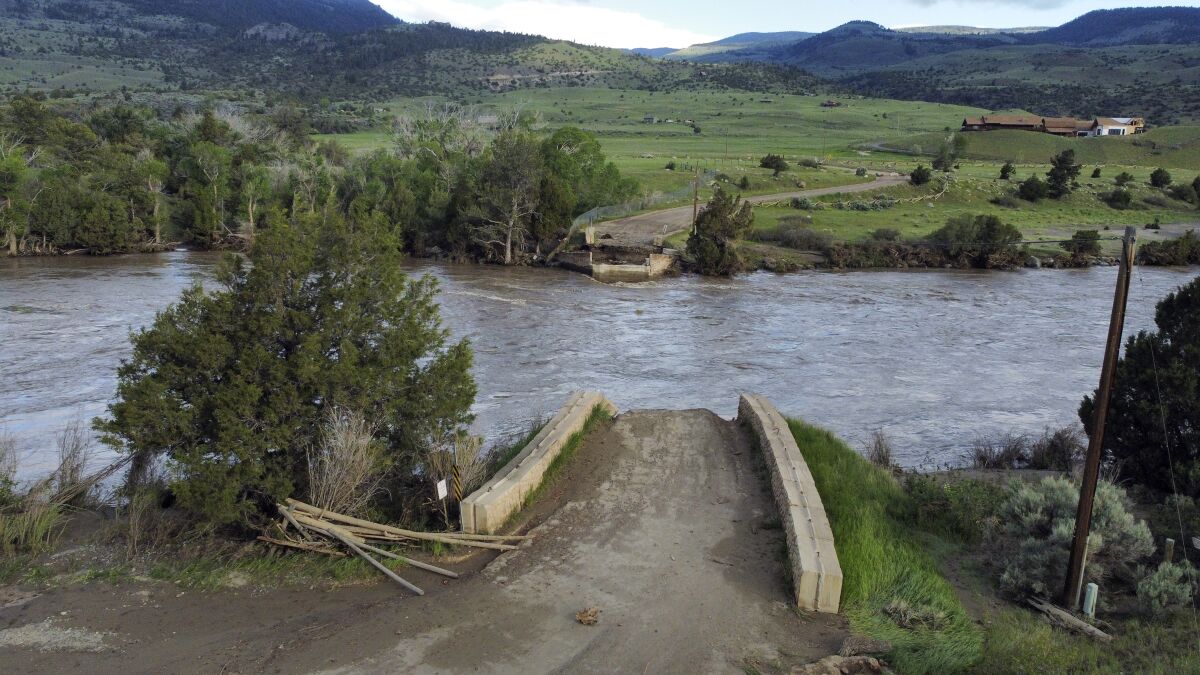 A washed out bridge shown along the Yellowstone River Wednesday, June 15, 2022, near Gardiner, Mont. Historic floodwaters that raged through Yellowstone National Park may have permanently altered the course of a popular fishing river and left the sweeping landscape forever changed. (AP Photo/Rick Bowmer)