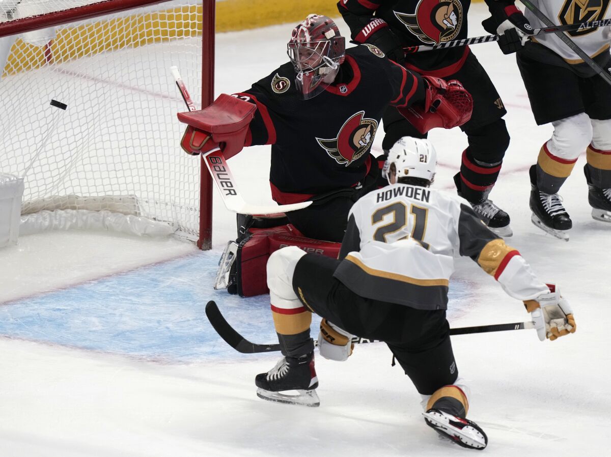 Vegas Golden Knights center Brett Howden watches his deflection sail past Ottawa Senators goalie Filip Gustavsson for a goal during the second period of an NHL hockey game Thursday, Nov. 4, 2021, in Ottawa, Ontario. (Adrian Wyld/The Canadian Press via AP)
