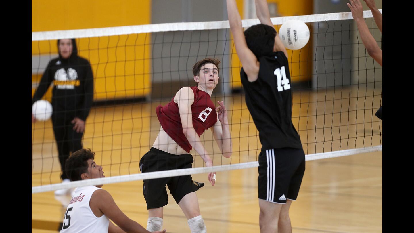 Ocean View High's Jackson Petrovich (8) records a kill over Godinez's Cesar Mascareno during the first set of a Golden West League match at Godinez on Monday.