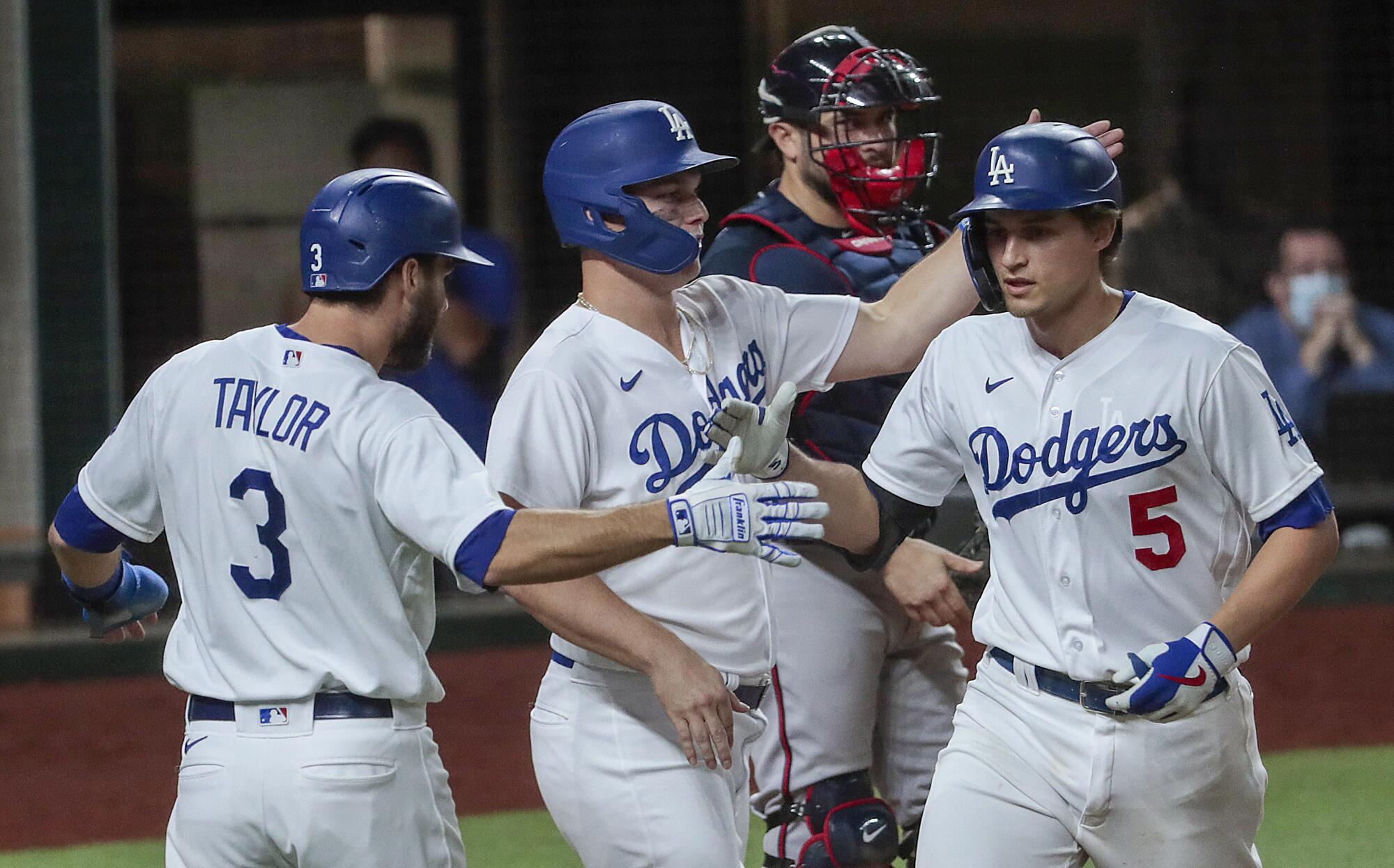 Dodgers shortstop Corey Seager is congratulated by Joc Pederson and Chris Taylor after hitting a three-run home run