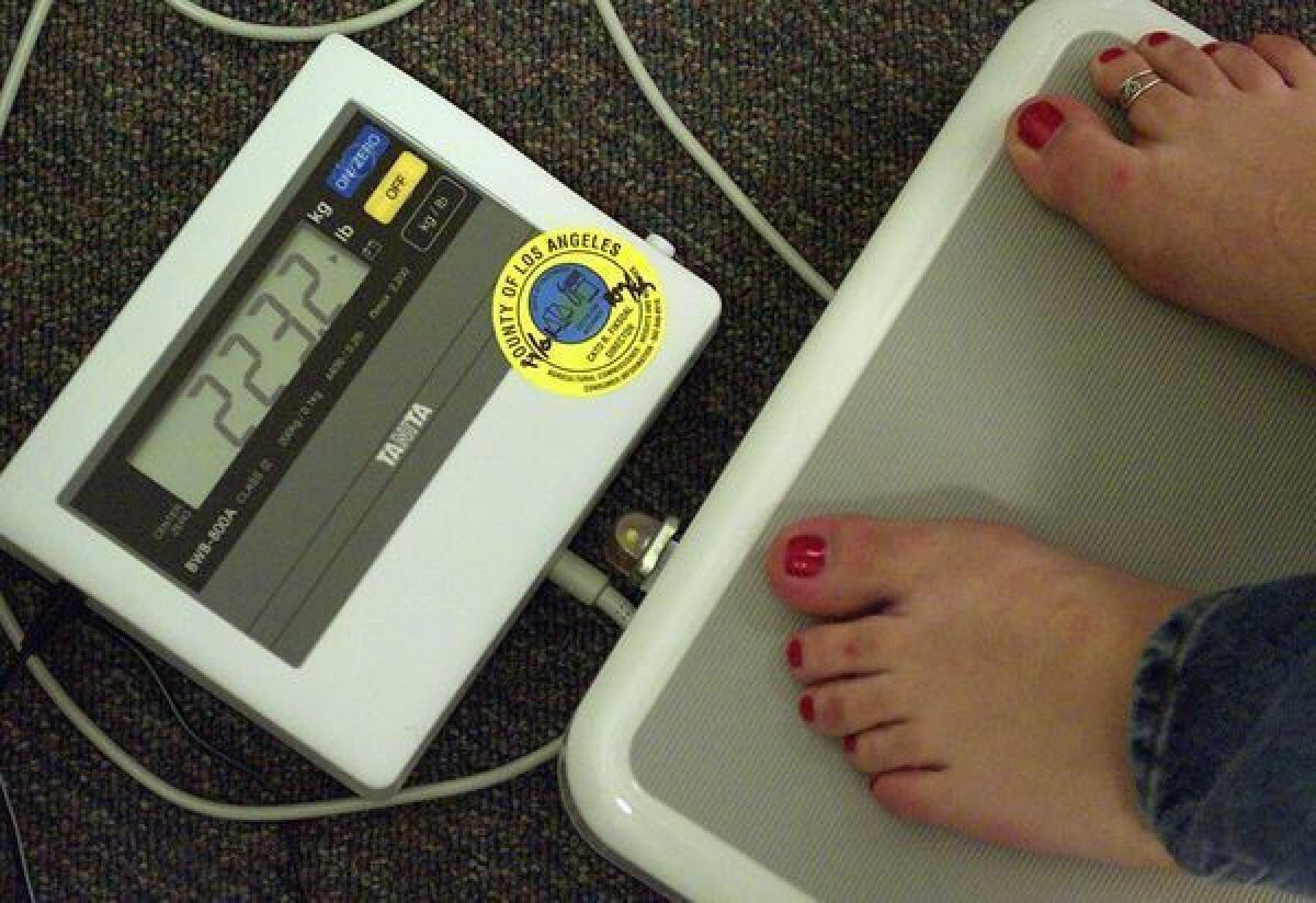 Weigh-in at a Weight Watchers meeting in Pasadena. 2013 brings new resolutions to shed pounds.