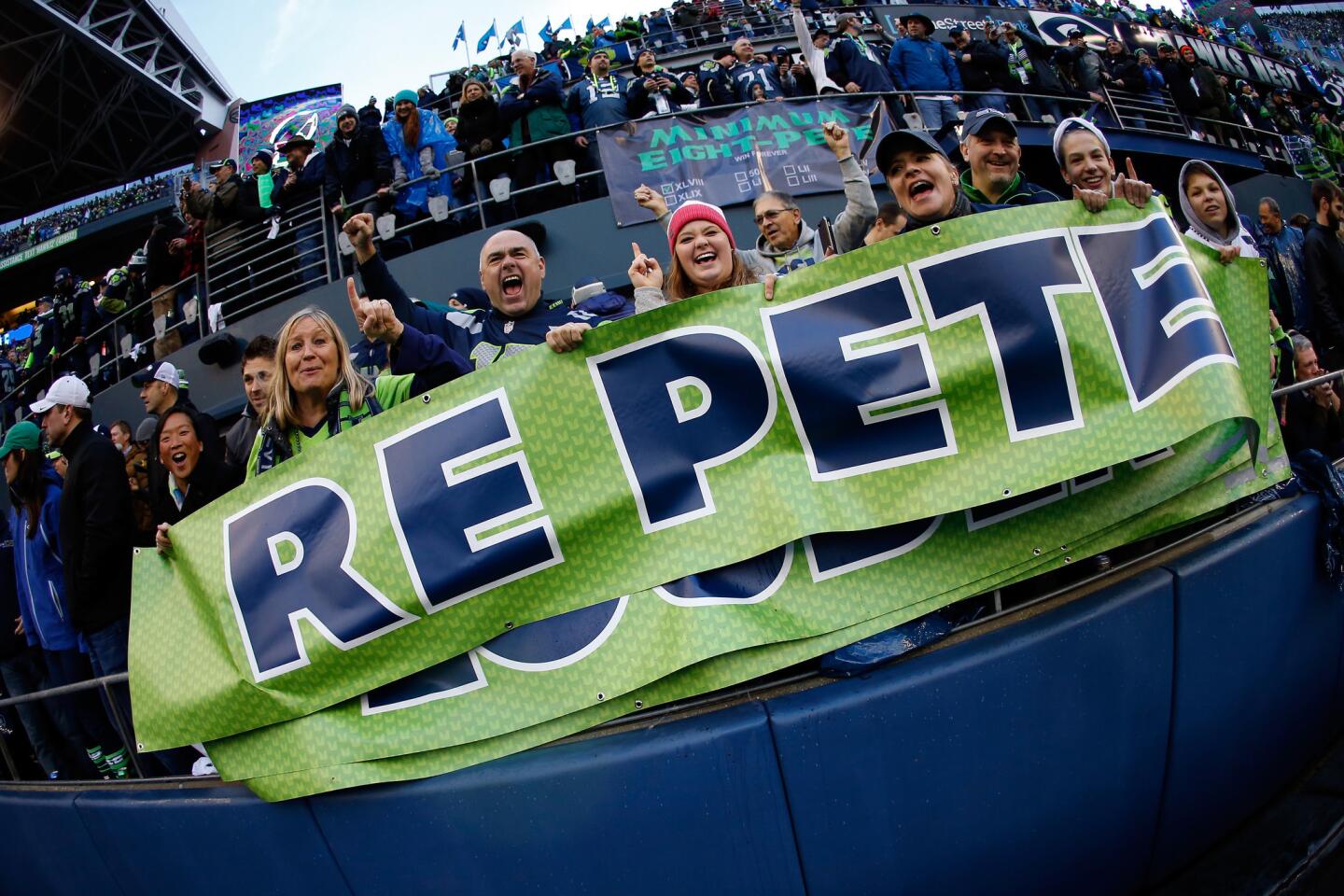 Fans cheer for the Seahawks in the second half of the NFC championship game against the Green Bay Packers on Sunday. Seattle will return to the Super Bowl after a 28-22 overtime victory.