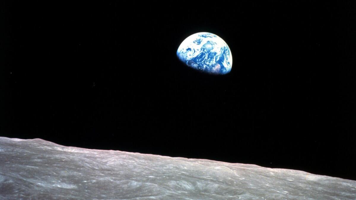 This Dec. 24, 1968, photo taken during the Apollo 8 mission shows Earth beyond the surface of the moon.