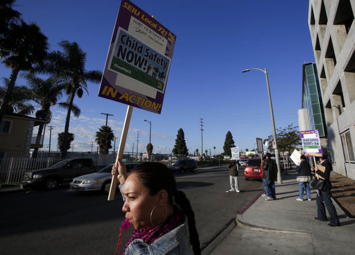 Brandie McMiller, an investigator with the Department of Children and Family Services, takes part in rally outside the county of Los Angeles building on Vermont Avenue in South L.A. on Dec. 5, 2013.