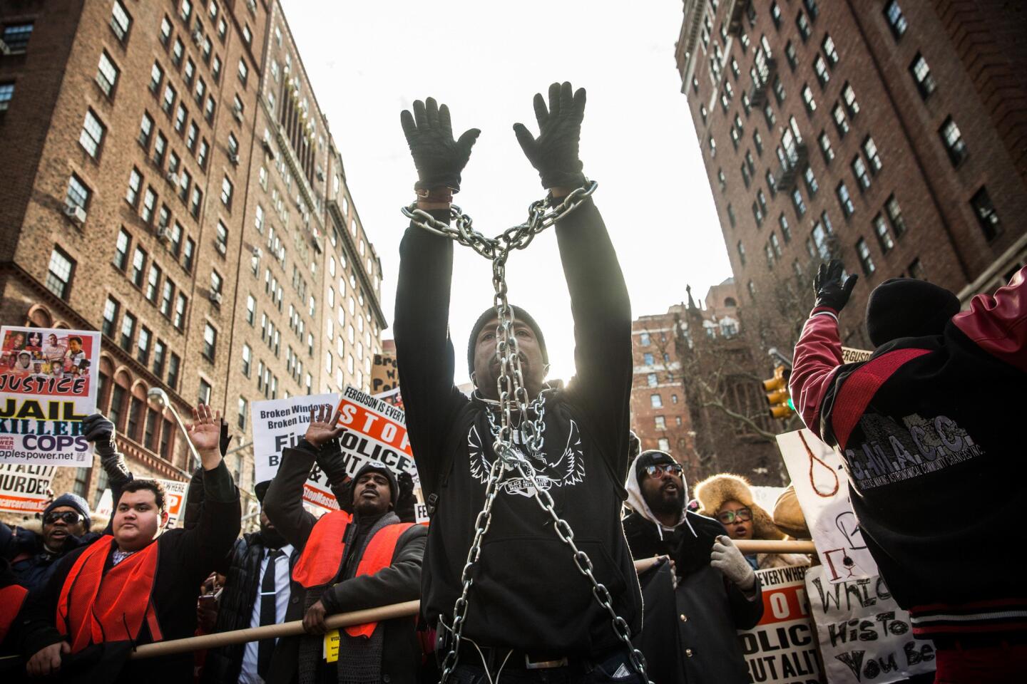 A man is wrapped in chains as people march in the National March Against Police Violence through the streets of Manhattan on December 13, 2014 in New York City.