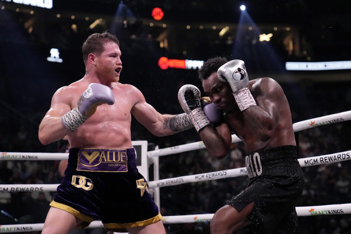 Canelo Álvarez, left, punches Jermell Charlo during their super middleweight title fight at T-Mobile Arena on Saturday.