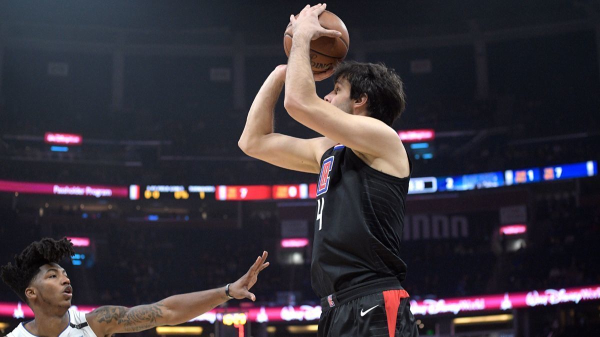 Clippers guard Milos Teodosic goes up for a shot in front of Orlando Magic guard Elfrid Payton, during the first half on Wednesday.