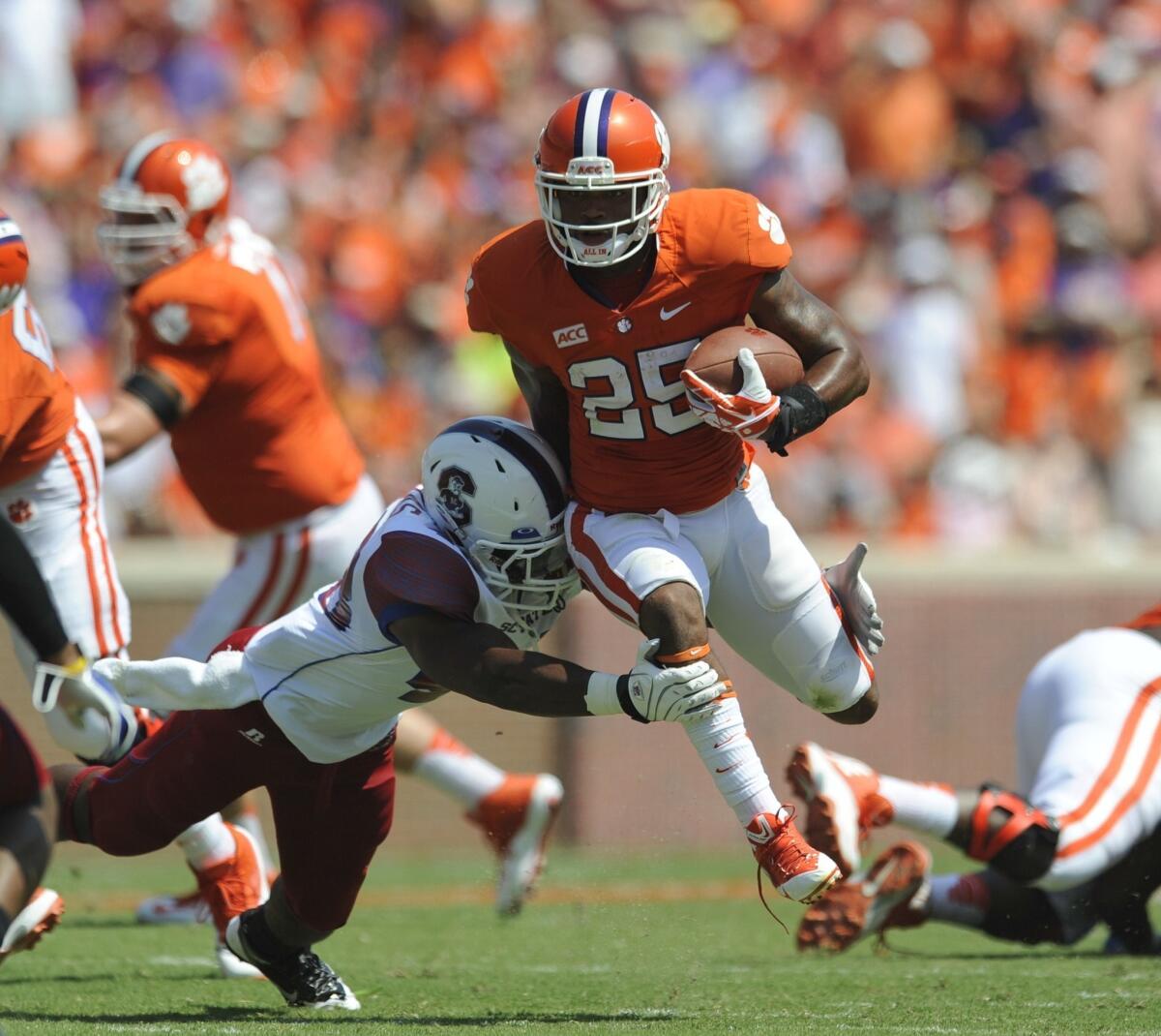 Clemson running back Roderick McDowell breaks a tackle attempt by South Carolina's Joe Thomas during the first half of the Tigers' win Saturday.