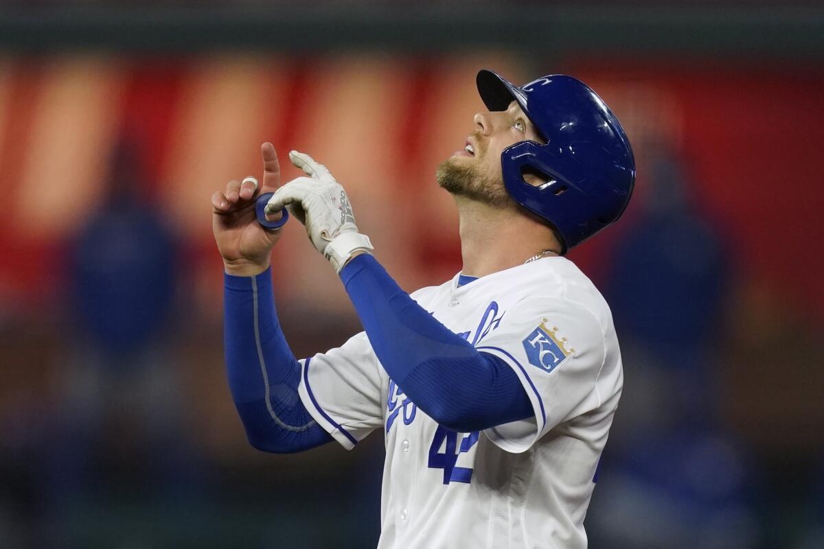 Kansas City Royals' Hunter Dozier celebrates at second base after hitting an RBI-double during the fourth inning of a baseball game against the Toronto Blue Jays, Thursday, April 15, 2021, in Kansas City, Mo. (AP Photo/Charlie Riedel)