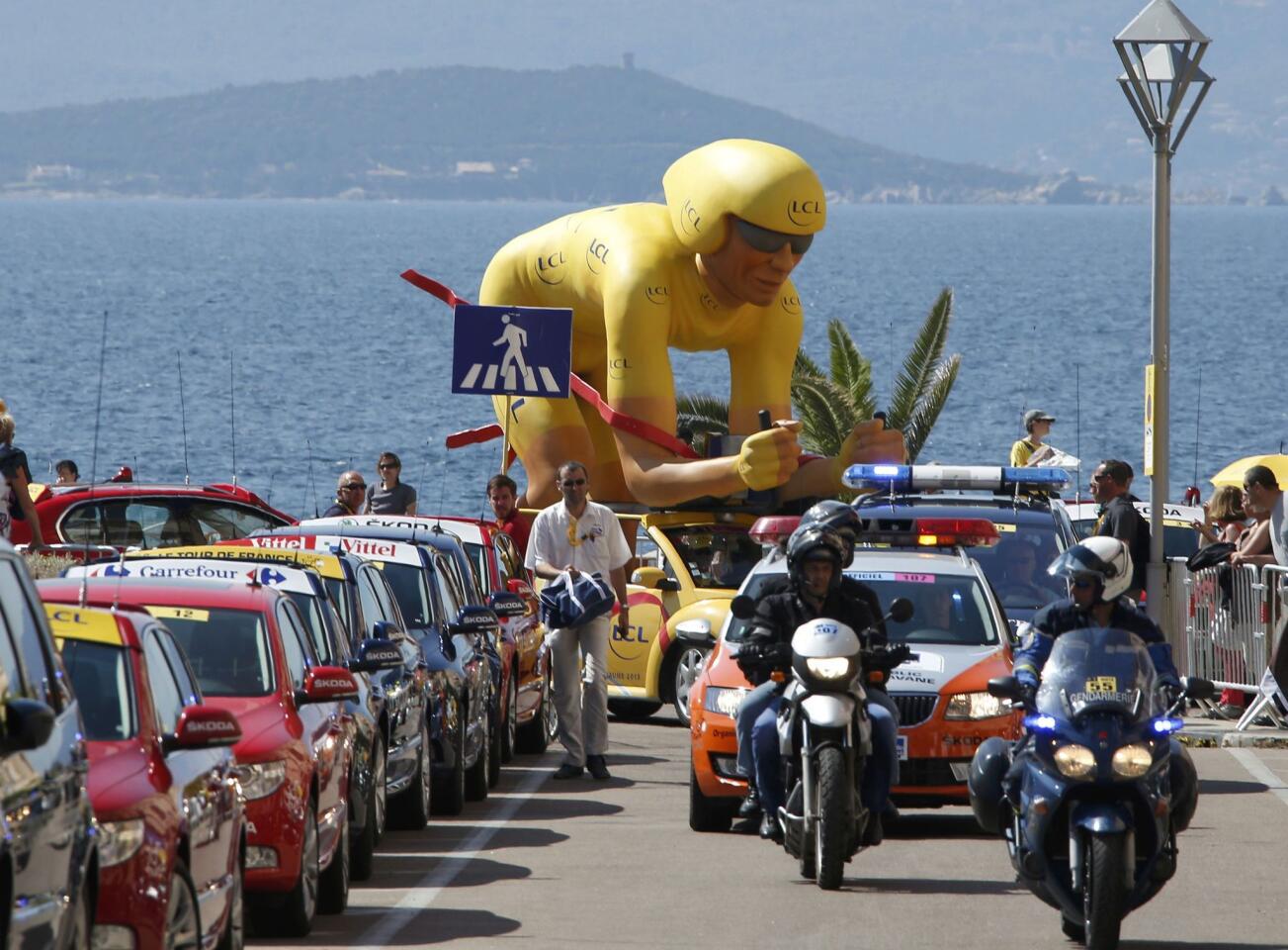 Publicity vehicles from the Tour de France caravan make their way during the 145,5 km third stage of the centenary Tour de France cycling race from Ajaccio to Calvi