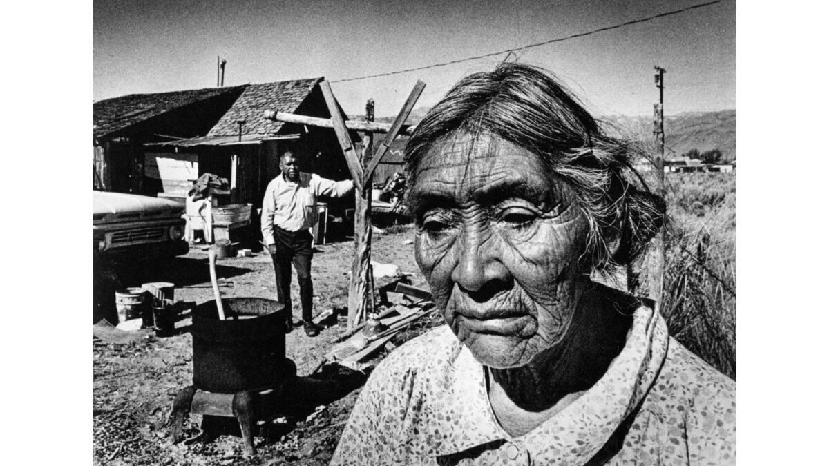 August 1972: Mrs. Lucile Gilbert, a Paiute, stands in front of home in Bridgeport, Calif.