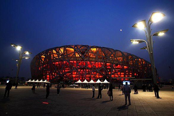 Crowds of tourists visit the National Stadium, known as the "Bird's Nest", on Dec. 10 in Beijing. The Bird's Nest, the main stadium during Beijing 2008 Olympic Games, has become the city's most popular scenic spot, with more than 10,000 visitors a day. Times architecture critic Christopher Hawthorne: "Soaring Chinese ambition, its sizzling economy (which has since dramatically cooled), bold use of new engineering and the rise of world-famous starchitects came together to produce a group of buildings  avant-garde and unapologetically monumental at the same time  the likes of which we may never see in China, or elsewhere, again."
