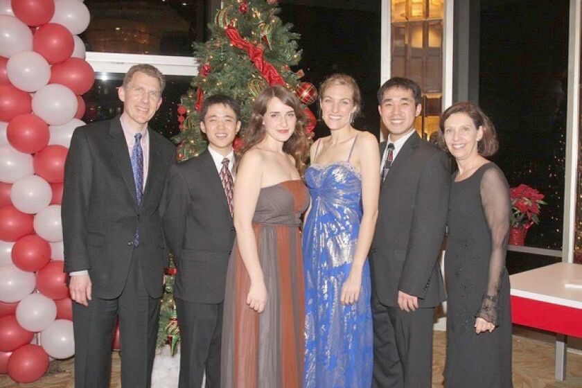 The season erupted in song on Dec. 19 when the Los Angeles Children's Chorus' elite Chamber Singers performed a Holiday Salon Concert. The chorus' board Chairman, David Scheidemantle, left, and Artistic Director Anne Tomlinson flank alumni who returned to perform with the Chamber Singers: from second left, Albert Wonjae Pae, Ariadne Greif, Adrienne Pardee and Andrew Wonjun Pae.