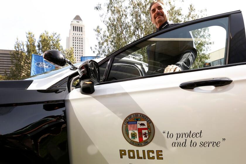 LOS ANGELES, CA - APRIL 10, 2017- LAPD Chief Charlie Beck takes a close look at the new pursuit-rated hybrid police car, the all-new Ford Police Responder Hybrid Sedan at Los Angeles Police Headquarters on Monday morning April 10, 2017. The car is certified by police agencies to be tough enough to handle police pursuits for longer periods at different speeds and over obstacles such as curbs and flooded intersections. âOur mission to create safe and healthy communities in Los Angeles is achieved through sustainable approaches in community policing, and that includes embracing new technologies,â said Charlie Beck, Los Angeles Police Department Chief. âPatrol vehicles are a police officerâs office, and we expect them to not only be economically and environmentally efficient, but also an effective tool for fighting crime in major metropolitan areas.â (Al Seib / Los Angeles Times)