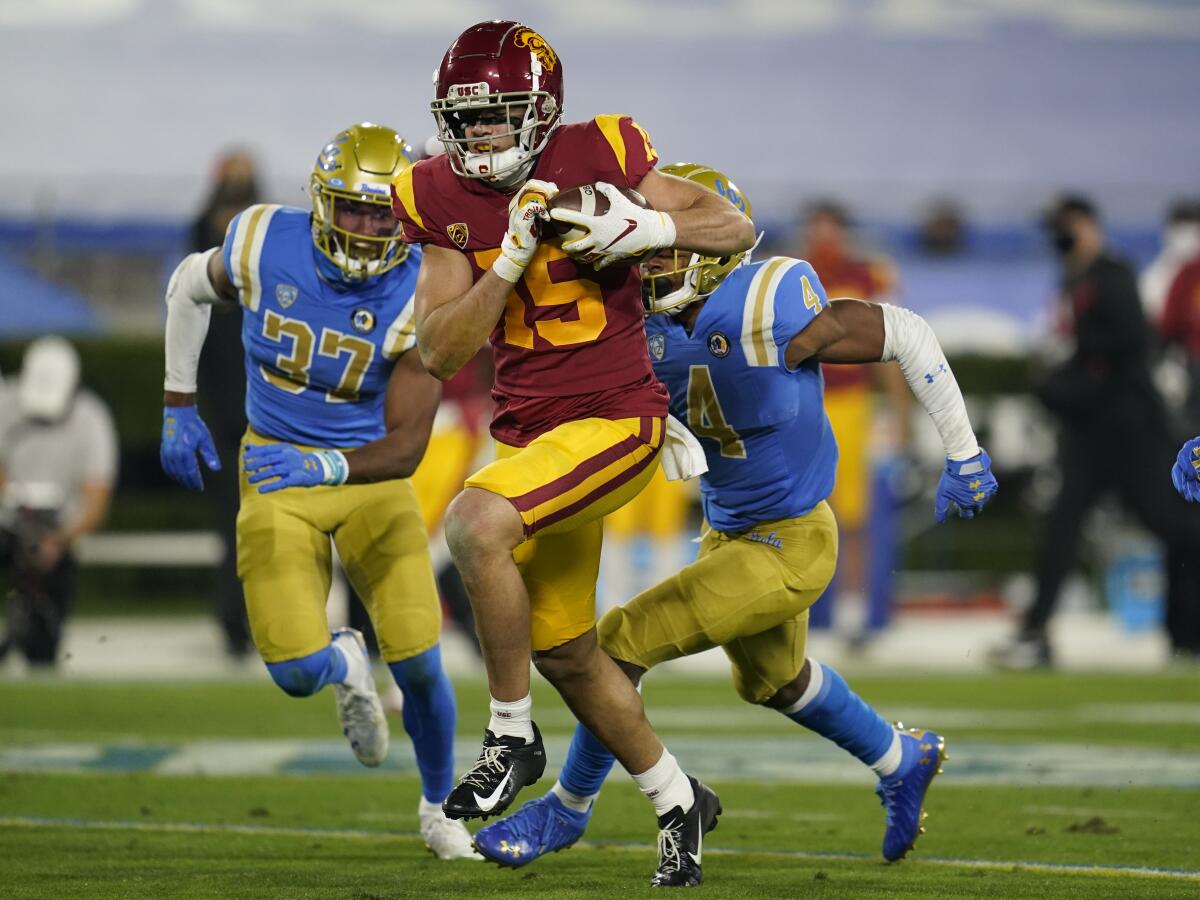 USC wide receiver Drake London runs to the end zone on a 65-yard touchdown against UCLA.