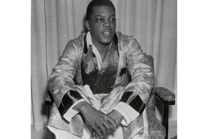 (Original Caption) House hunting Willie Mays, the centerfielder for the new San Francisco Giants appeared in his bathrobe and slippers this morning to declare himself deeply disappointed, but "not mad at anybody" when neighborhood pressure resulted in refusal of his offer of $37,500 for a new home near St. Francis Wood Section of San Francisco. San Francisco Mayor George Christopher, one of the leaders in the movement to bring the Giants to San Francisco, issued this statement; "San Francisco is a very understanding city and it is not our practice to preclude anyone living where he wants to, regardless of race. On the other hand, no law requires an owner to dispose of his property. What's happened is not in accordance with San Franciso's traditions."