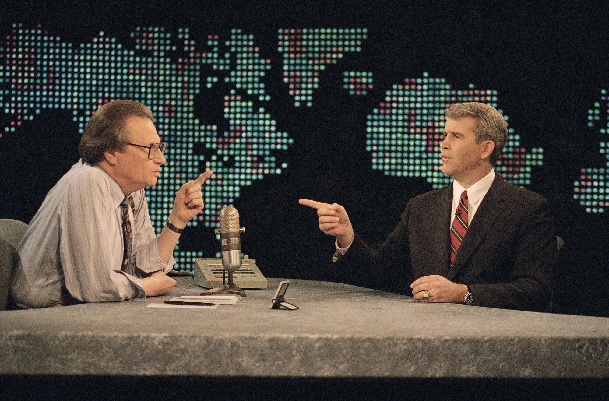 Oliver North and host Larry King prior to the start of CNN's "Larry King Live" in Washington on Jan. 26, 1994.