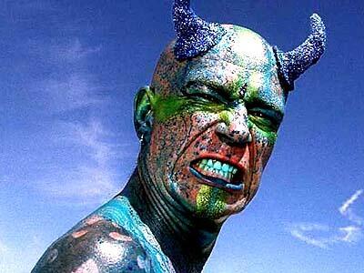 Mark Day of Santa Cruz is painted with food coloring to augment his horns. Outrageous costumes are part of the spectacle.