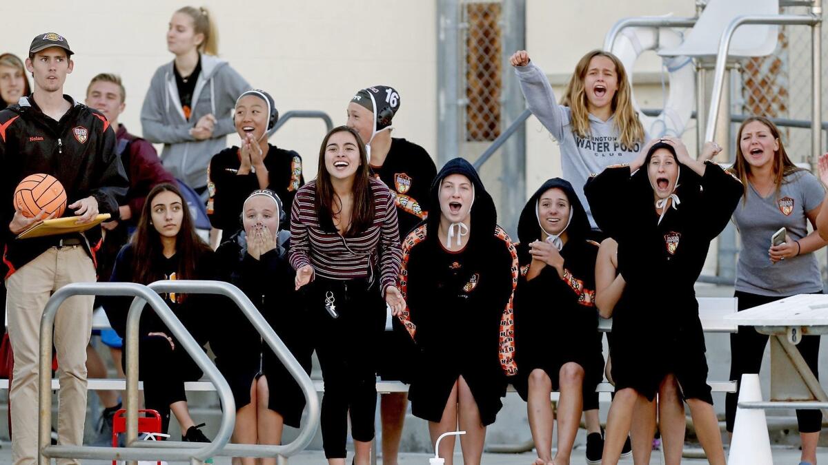 Huntington Beach High's players react after Chloe Reiner (not pictured) ties the game at 10-10 to force overtime against Murrieta Valley in the first round of the CIF Southern Section Division 2 playoffs on Wednesday.