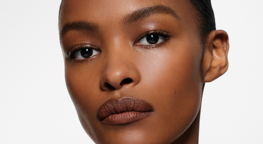A woman looking at the camera. Model. Brown eyes. Lipstick.