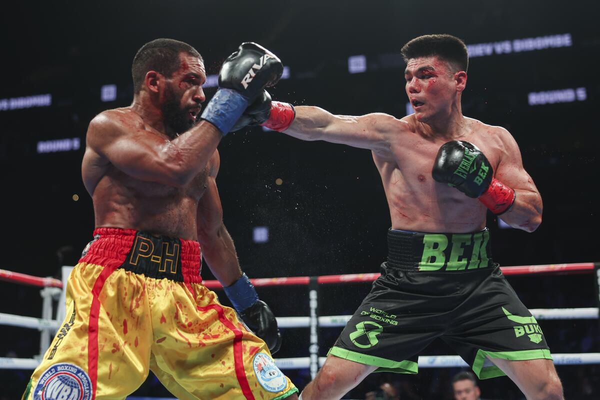 Bektemir Melikuziev, right, punches Pierre Dibombe during his victory Saturday at Barclays Center.