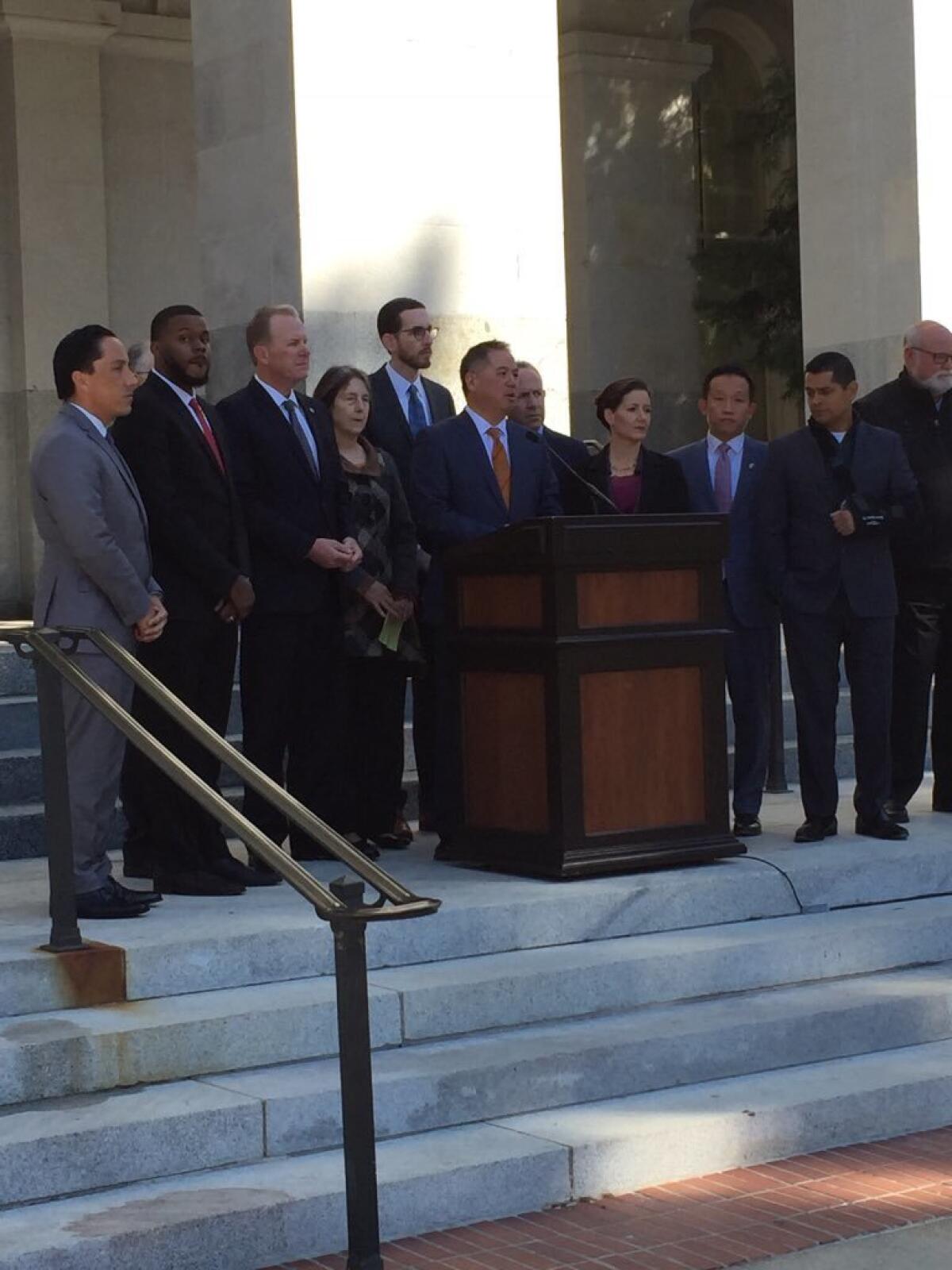Assemblyman Phil Ting (D-San Francisco), center, joins mayors from across California to announce legislation for homelessness funding.