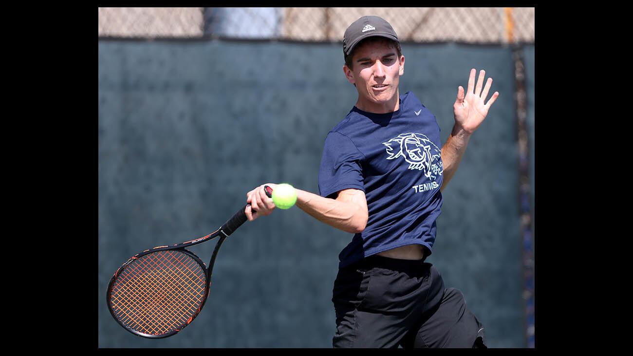 Crescenta Valley High tennis player Kevin Rowe returns the ball in match vs. St. Francis at home in La Crescenta on Wednesday, April 25, 2018.