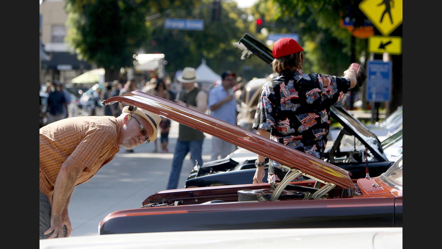 Bob Paetz of Riverside takes a close look at a 1964 Chevy two-door wagon at the 6th annual Downtown Burbank Car Classic on San Fernando Road.