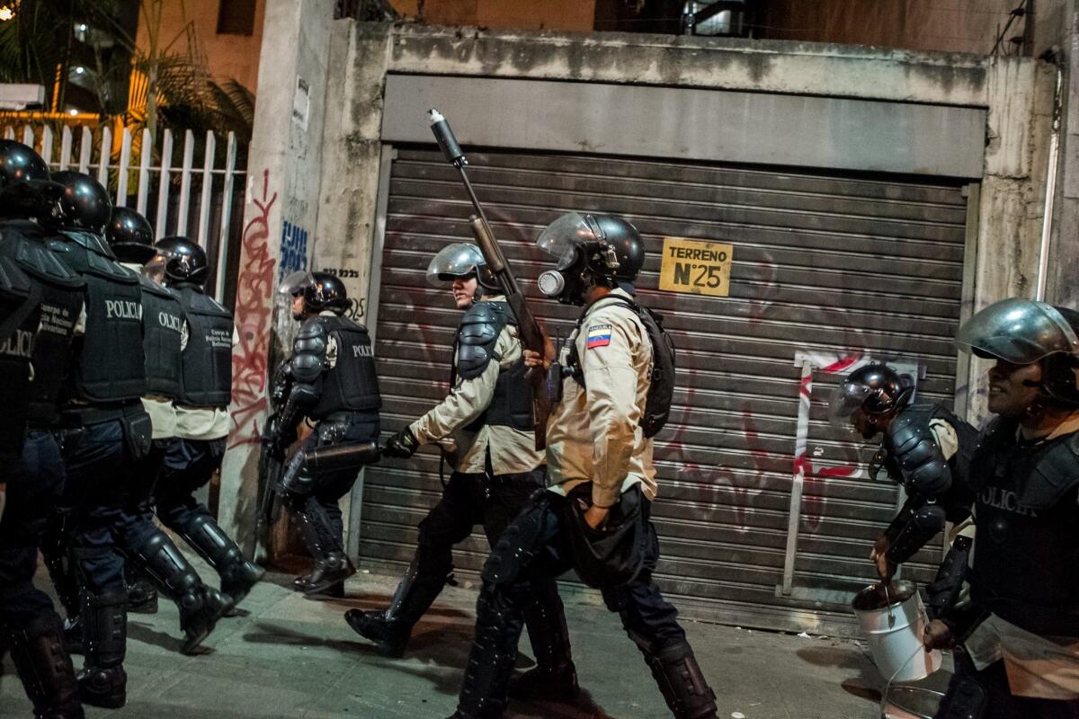 Venezuelan police clash with anti-government demonstrators in Caracas.