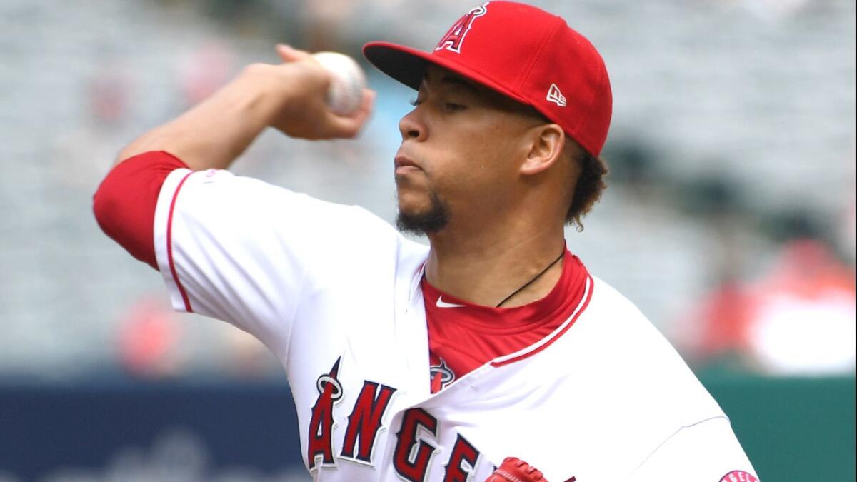 Hansel Robles delivers a pitch during the first inning of the Angels' game against the Mariners on Sunday.