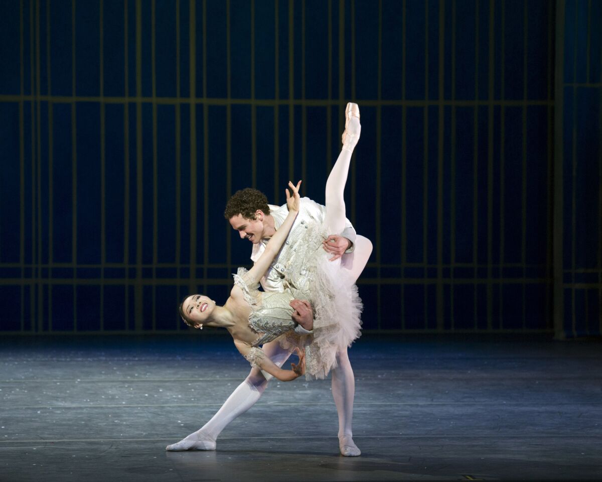 A ballet dancer dips a ballerina