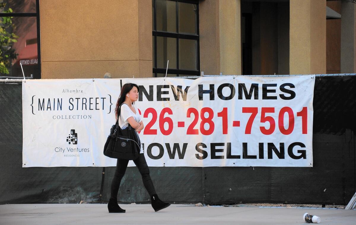 According to data from the Census’ Current Population Survey, those moving out of California over the last 15 years listed housing as one of the most common factors, behind only family and job concerns. Above, a banner advertising new homes for sale in Alhambra in 2013.