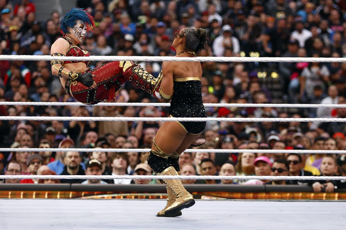 Asuka drop kicks Bianca Belair during the RAW women's championship match at Wrestlemania 39.