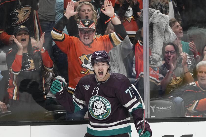 Fans cheer as Anaheim Ducks' Frank Vatrano (77) celebrates his goal against the Carolina.