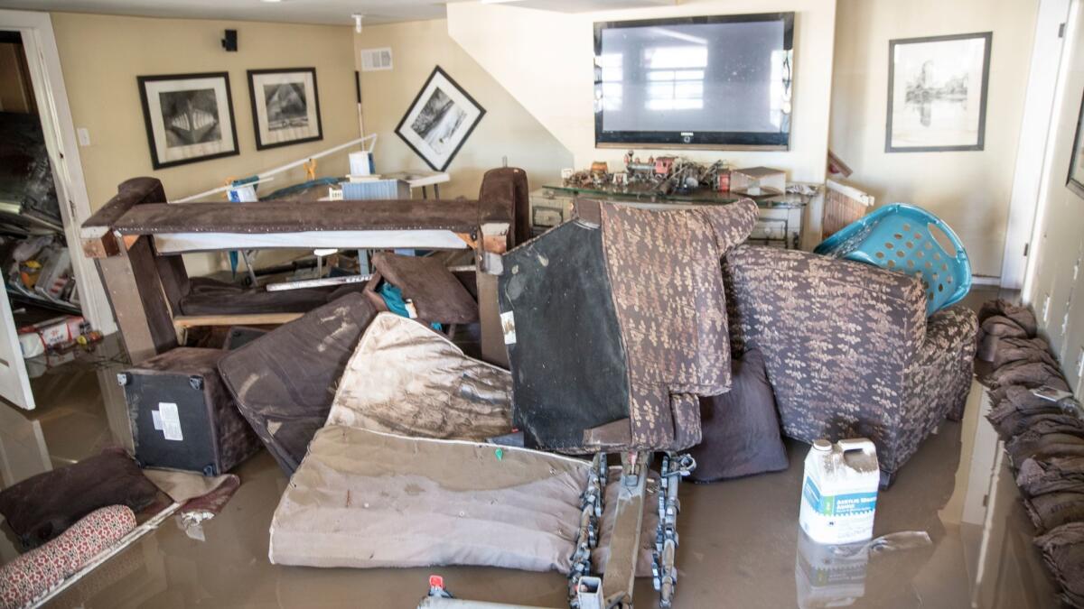 Ruined furniture is piled in a house near Coyote Creek after this week's San Jose flooding.