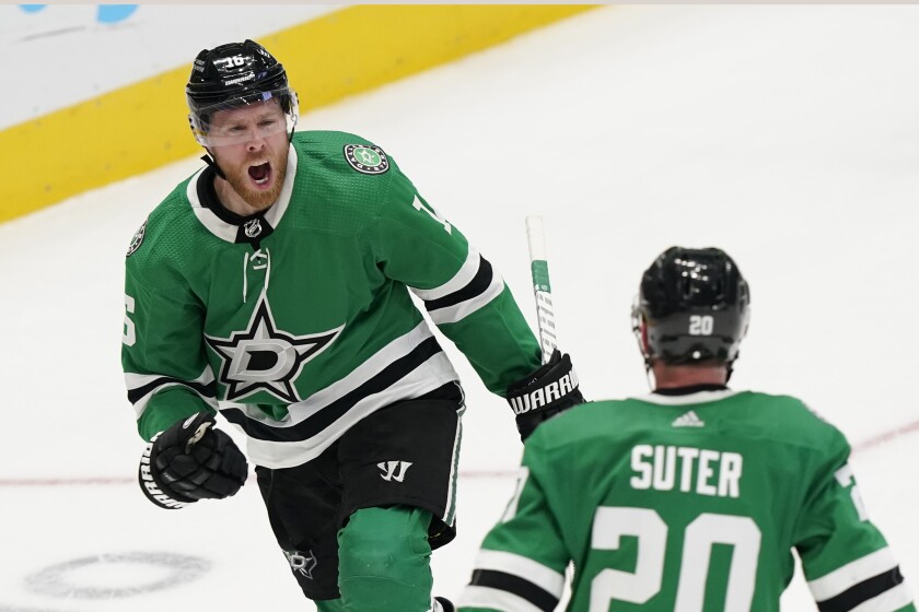 Dallas Stars center Joe Pavelski (16) celebrates scoring a goal in front of teammate Ryan Suter (20) during the third period of an NHL hockey game against the Pittsburgh Penguins in Dallas, Saturday, Jan. 8, 2022. The Stars won 3-2. (AP Photo/LM Otero)