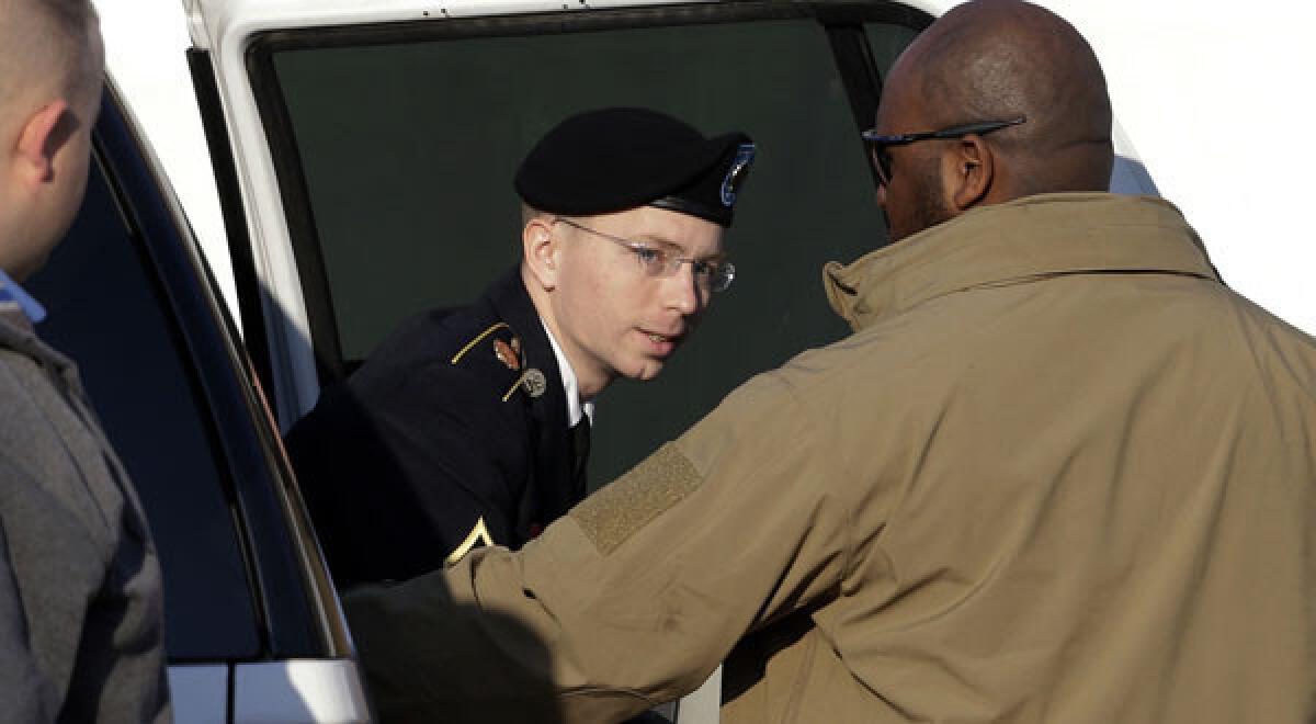Army Pfc. Bradley Manning steps out of a security vehicle as he is escorted into a courthouse in Fort Meade, Md.