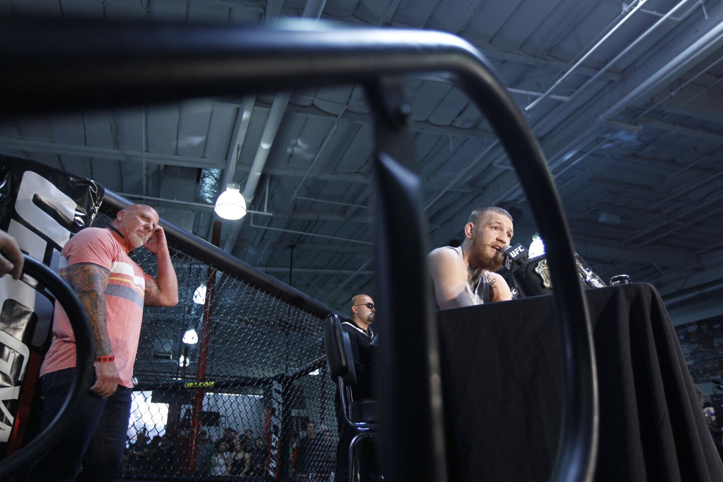 Conor McGregor, right, speaks during a news conference at UFC Gym in Torrance on Feb. 24.