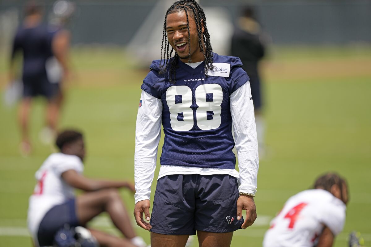 Houston Texans wide receiver John Metchie III smiles during a rookie minicamp practice in May.