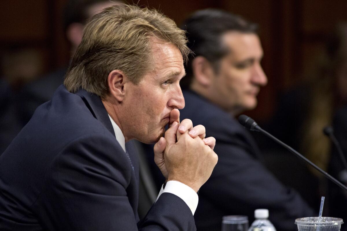 Sen. Jeff Flake (R-Ariz.), left, and Sen. Ted Cruz (R-Texas) listen as the Senate Judiciary Committee meets in a markup session to examine proposed changes to immigration reform legislation, on Capitol Hill in Washington.