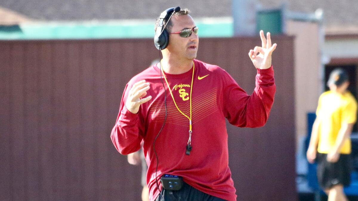 USC Coach Steve Sarkisian motions to the offense during a fall camp practice at Howard Jones Field on Thursday.
