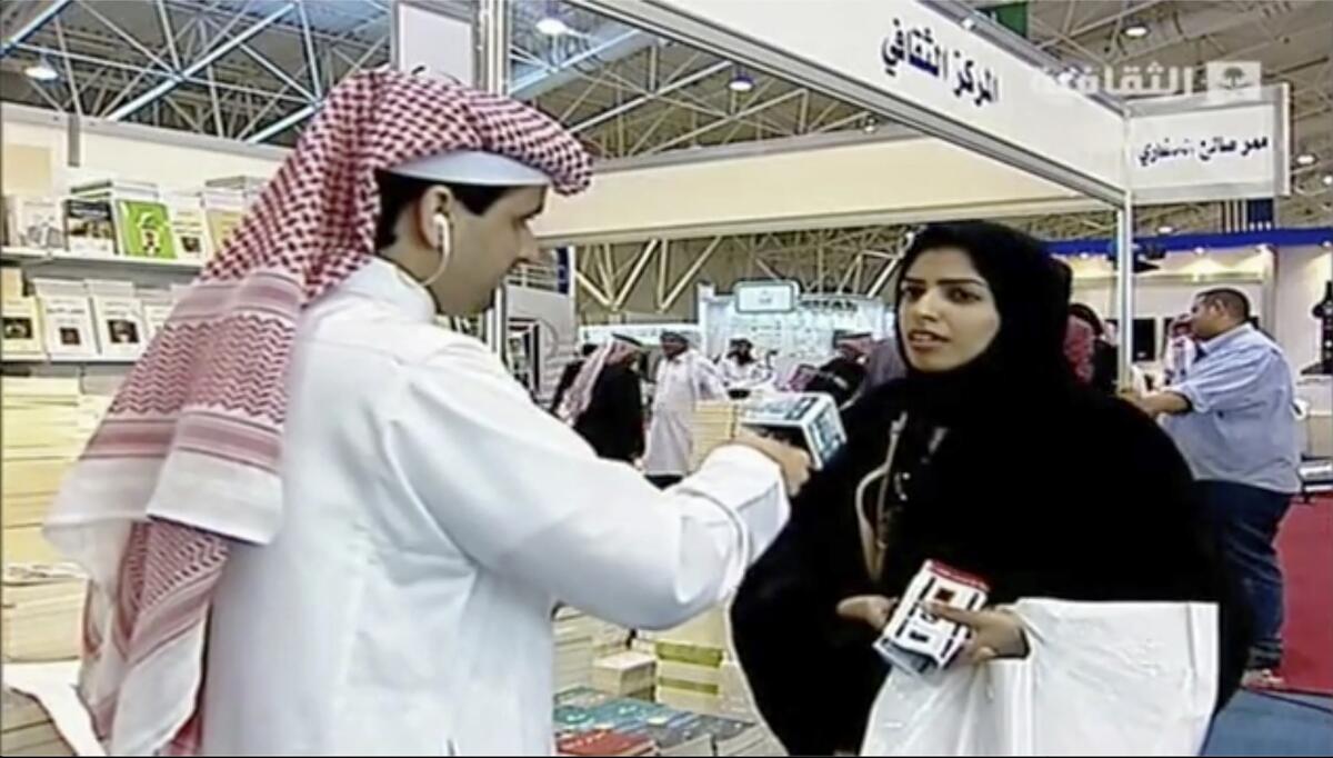 In this frame grab from Saudi state television footage, doctoral student and women's rights advocate Salma al-Shehab speaks to a journalist at the Riyadh International Book Fair in Riyadh, Saudi Arabia, in March 2014. A Saudi court has sentenced al-Shehab to 34 years in prison for spreading "rumors" on Twitter and retweeting dissidents, according to court documents obtained Thursday, Aug. 18, 2022, a decision that has drawn growing global condemnation. (Saudi state television via AP)