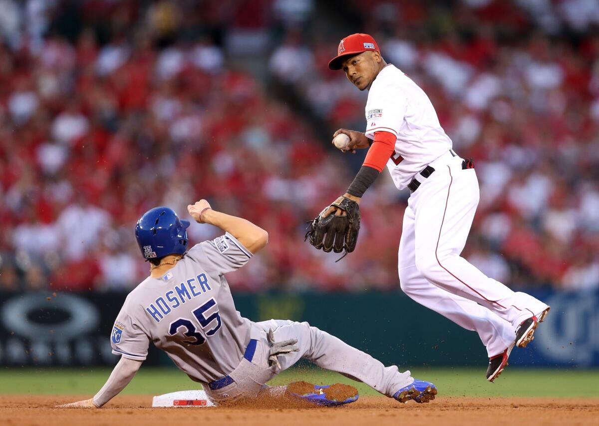 Angels shortstop Erick Aybar avoids the slide of the Royals' Eric Hosmer during a game in October.
