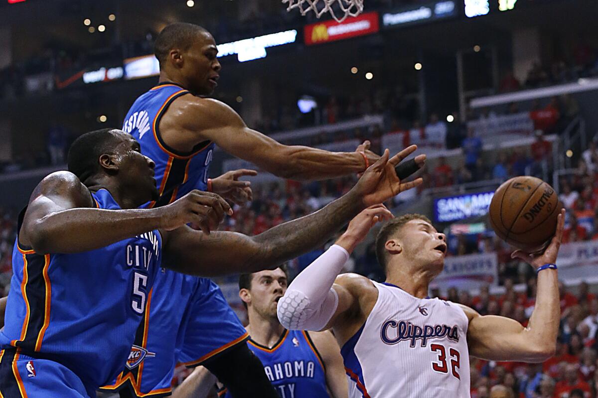 Clippers forward Blake Griffin controls the ball against Oklahoma City center Kendrick Perkins, left, and guard Russell Westbrook during Game 3 of the teams' Western Conference playoff series.