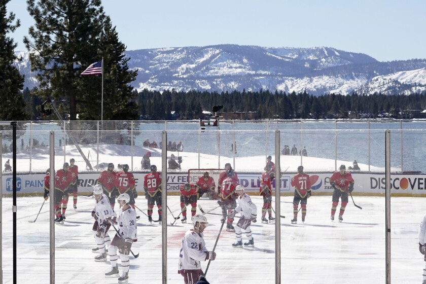 The Colorado Avalanche, in white, and the Vegas Golden Knights, in red, prepare to play in Stateline, Nev., on Feb. 20, 2021.