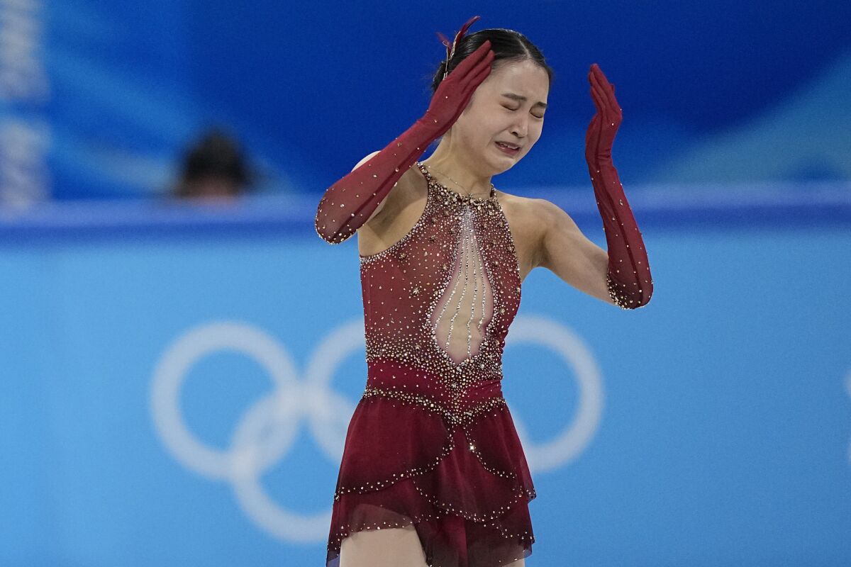 Zhu Yi of China reacts in the women's team free skate program during the figure skating competition