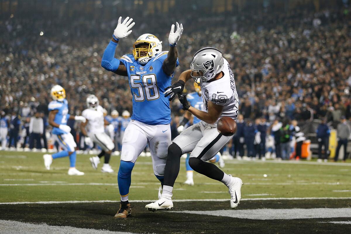 Chargers linebacker Thomas Davis breaks up a pass intended for Raiders receiver Hunter Renfrow during a game Nov. 7. 